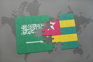 puzzle with the national flag of saudi arabia and togo on a world map background.