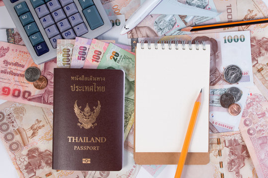 Thai Passport with Thai money banknote, Thai coin and airplane. The passport of Thai citizen and Thai banknote on white background.