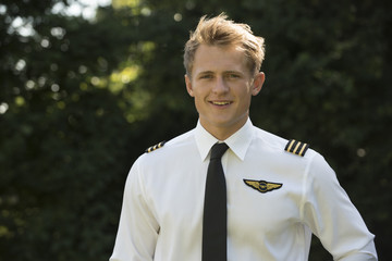 Portrait of a young airline pilot in uniform