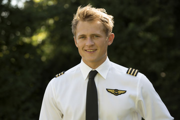 Portrait of a young airline pilot in uniform