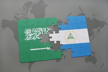 puzzle with the national flag of saudi arabia and nicaragua on a world map background.