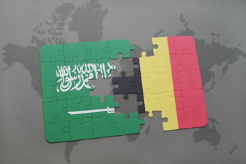 puzzle with the national flag of saudi arabia and belgium on a world map background.