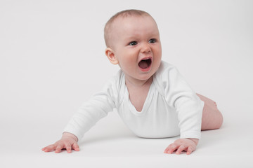 baby on a white background in a white pajamas