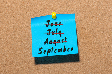 September start and summer end concept written on sticker pinned at notice board. Striked June, July, August