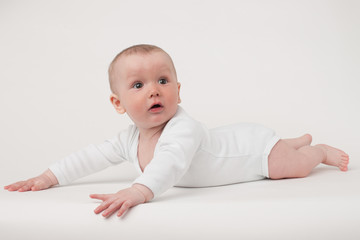 Fototapeta premium baby on a white background in a white pajamas