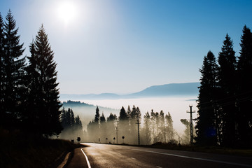 Landscape winter hill scene with fog.