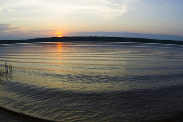Sunset on the Volga river, the sun sets over the horizon