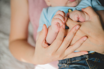baby hand holding mother