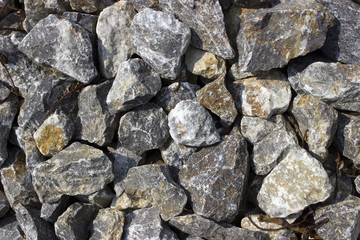 Rough uneven gray stone background old curve sprinkled gravel