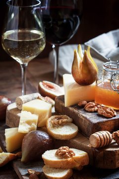 White and red wine, cheese, figs, nuts, honey and bread, vintage