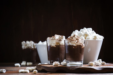 Winter chocolate dessert with marshmallows, vintage wooden backg