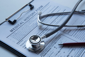 Medical concept with stethoscope on medical history form.