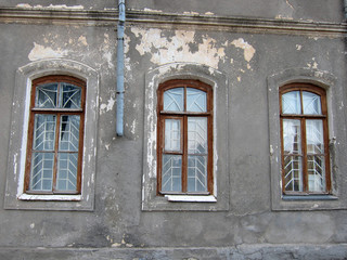 Fototapeta na wymiar Three windows in an old house