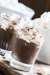 Winter chocolate dessert with marshmallows, vintage wooden backg