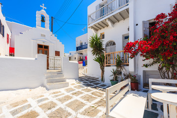 Square with church on whitewashed street with typical Greek architecture in beautiful Mykonos town, Cyclades islands, Greece