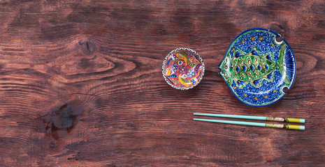 chopsticks and Chinese dishes on a rustic table