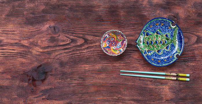 chopsticks and Chinese dishes on a rustic table