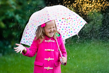 Little girl with umbrella in the rain