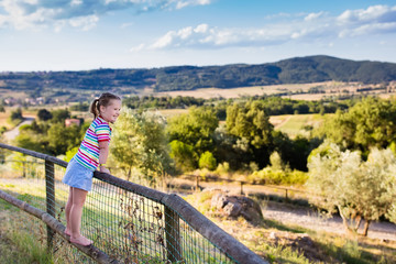 Naklejka premium Little girl watching landscape in Italy