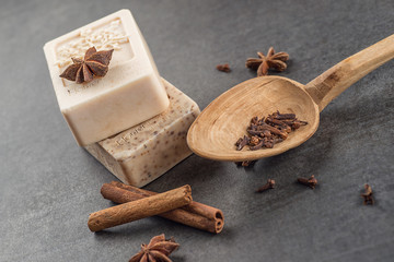 handmade ornamental soaps with cinnamons and anise on black background, product of cosmetics and...
