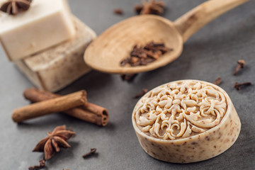 handmade ornamental soaps with cinnamons and anise on black background, product of cosmetics and body care