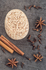 handmade ornamental soap with cinnamons and anise n black background, product of cosmetics and body...
