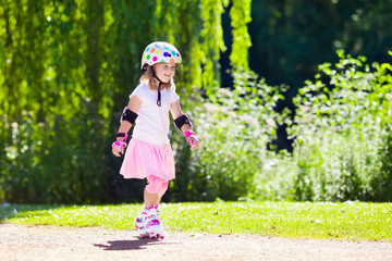 Little girl with roller skate shoes in a park