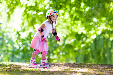 Little girl with roller skate shoes in a park
