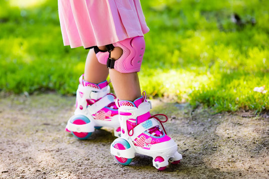 Little girl with roller skate shoes in a park