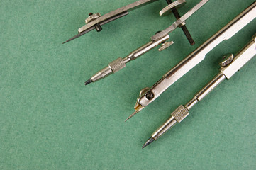 Old drawing tools on a green background
