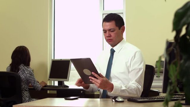 Office worker using tablet and cellphone