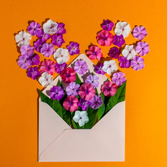 Colorful spring flowers in envelope, flower delivery and love concept