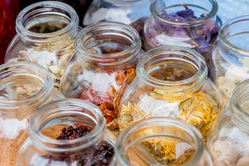 dried spices and tea in glass jars