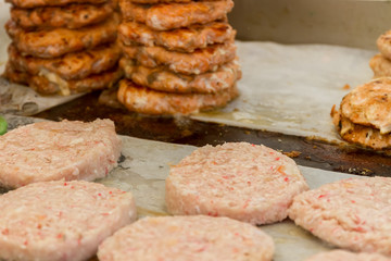 hamburgers and hotdogs cooking on grill outdoors