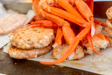 hamburgers and hotdogs cooking on grill outdoors