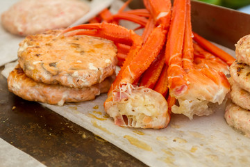 hamburgers and hotdogs cooking on grill outdoors