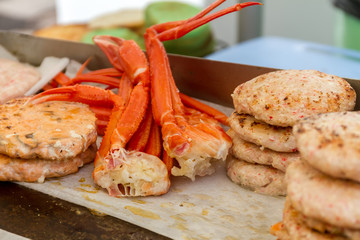 hamburgers and hotdogs cooking on grill outdoors