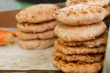 hamburgers and hotdogs cooking on grill outdoors