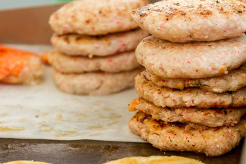 hamburgers and hotdogs cooking on grill outdoors