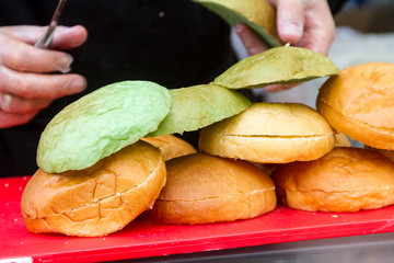 hamburgers and hotdogs cooking on grill outdoors