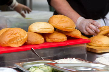 hamburgers and hotdogs cooking on grill outdoors