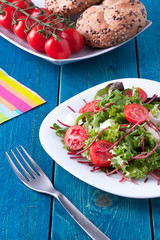 Fresh salad on a blue wooden table