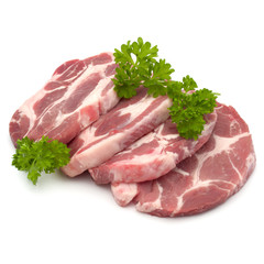 Raw pork neck chop meat with parsley herb leaves garnish isolate
