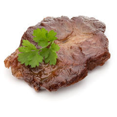 Cooked fried pork meat with parsley herb leaves garnish isolated