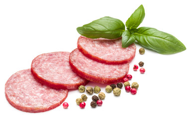 Salami smoked sausage slices, basil leaves and peppercorns isola