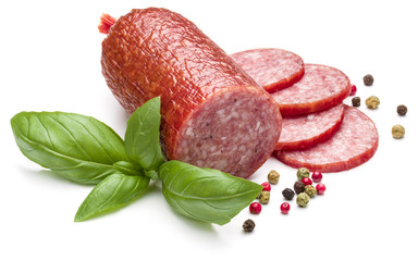 Salami smoked sausage, basil leaves and peppercorns isolated on