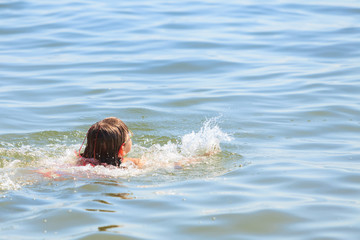 Little girl kid swimming in sea water. Fun