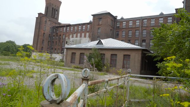 The green grasses on the outside of the buiding found in front of the old Kreenholm textile building in Narva