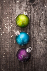 Christmas decoration ball on textured grungy wooden surface