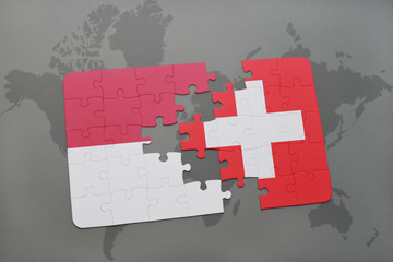 puzzle with the national flag of indonesia and switzerland on a world map background.